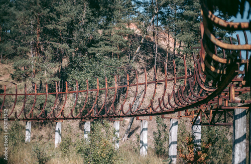 Fotografie, Tablou Old abandoned wooden bobsleigh track in summer by daylight