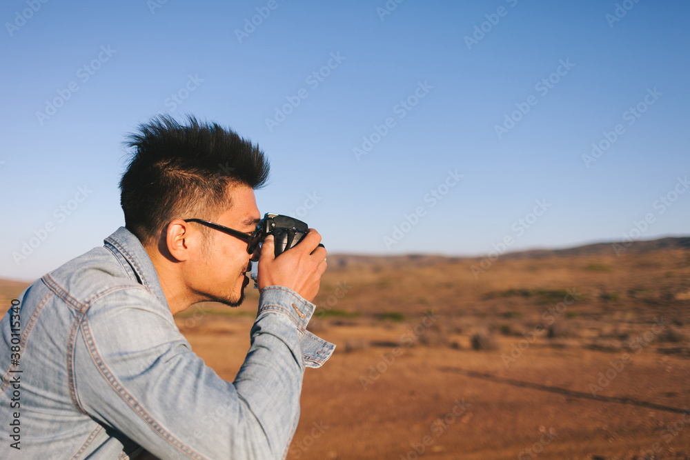 young photographer in Gobi desert,Xinjiang young photographer in Gobi desert,Xinjiang