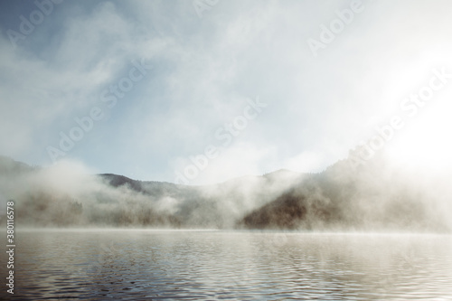 Foggy sunsrise at a mountain lake.