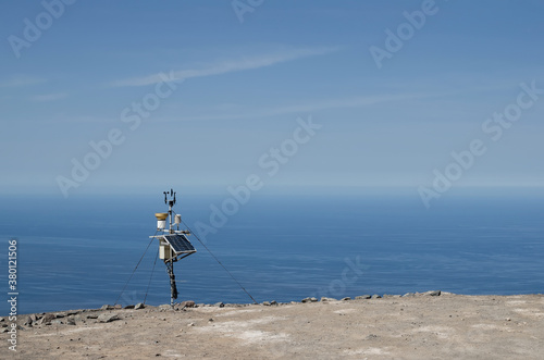 Solar panel at the cliff with ocean at the background photo