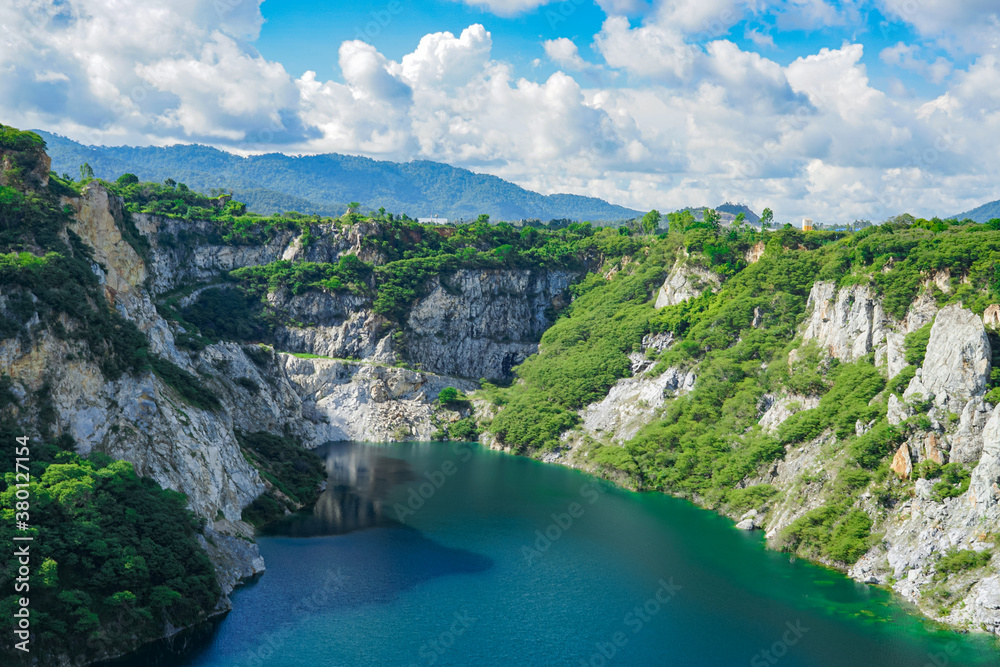 Grand Canyon Kiri, Old quarry with big lake, many trees and cloudy blue sky not far from Pattaya city in Chon Buri, Thailand Grand Canyon Kiri, Old quarry with big lake, many trees and cloudy blue sky not far from Pattaya city in Chon Buri, Thailand