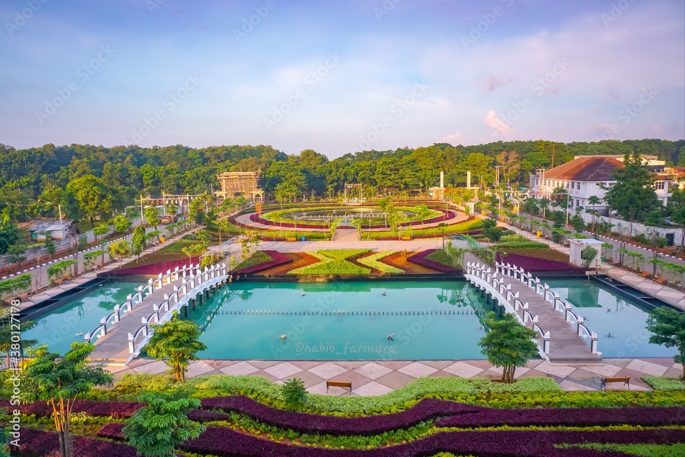 Fototapeta premium Beautiful flowers garden and bridge over the pool. 