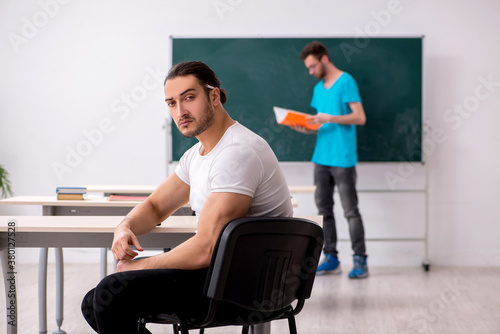 Two male pupils in bullying concept in the classroom