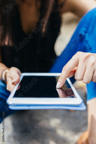 Female Finger Touching a Digital Tablet photo