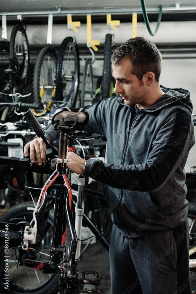 Young man fixing bikes at his workshop