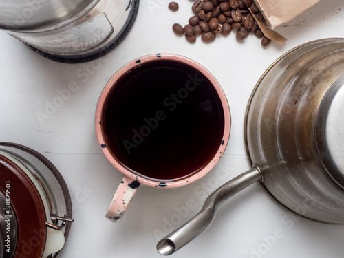 Millennial pink coffee mug with beans, pot, grinder, and french press photo