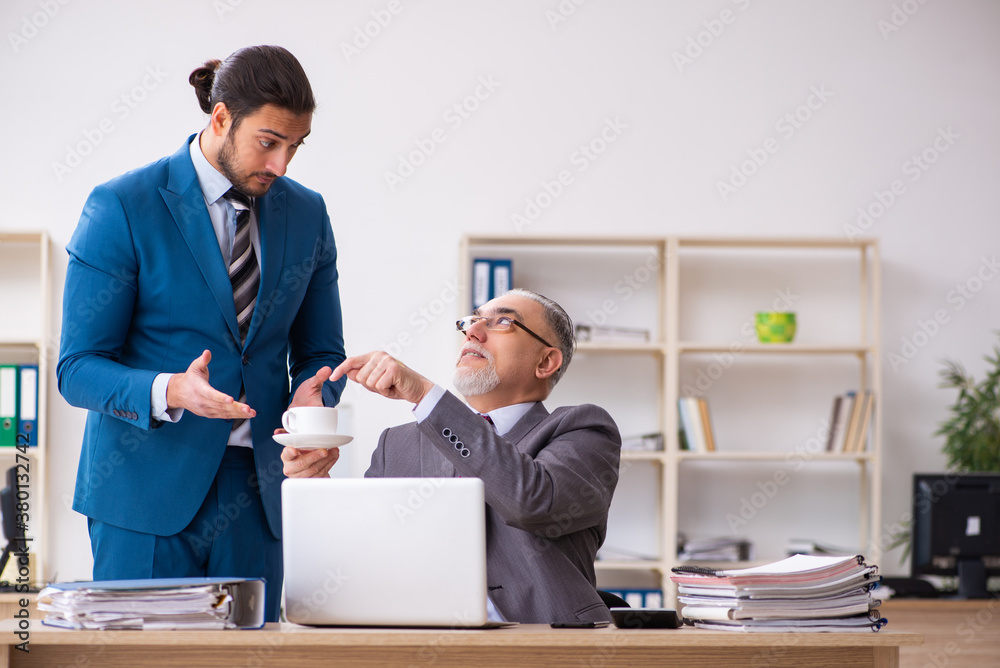 Two male colleagues working in the office Two male colleagues working in the office