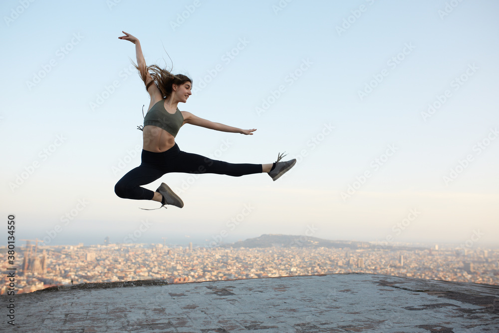 Young woman taking some air on the top of a roof Young woman taking some air on the top of a roof