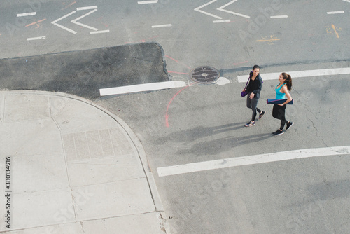 Wallpaper Mural Athletic women walking in city with yoga mats Torontodigital.ca