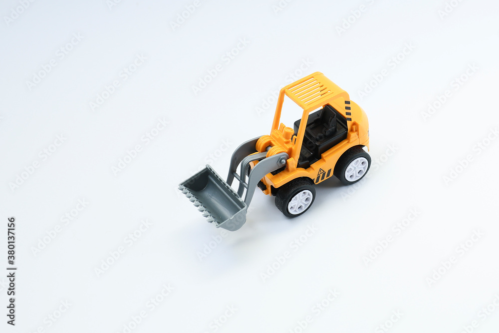 View from above of a toy bulldozer on white background 