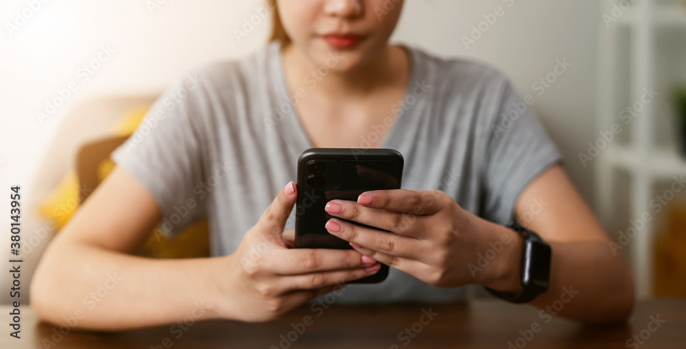 Woman holding a smartphone and using social media on internet. Woman holding a smartphone and using social media on internet.