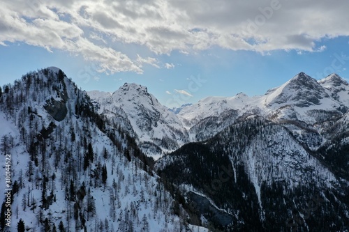 aerial snow covered mountain peaks in alps at winter 