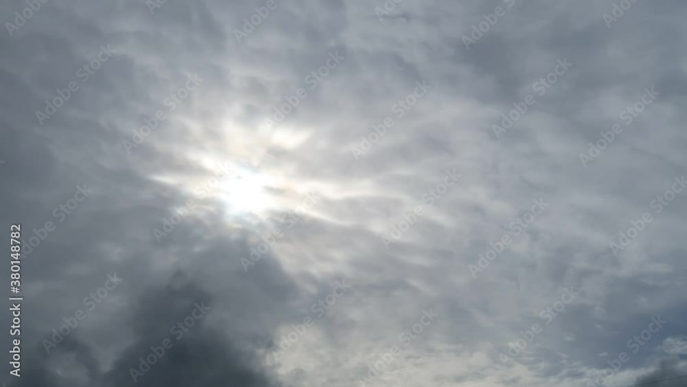 Dramatic gray & white cloud or dark scary cirrocumulus & wispy smoke cloudscape with bright sun light ray & sunbeam flare shining on sunrise sky in tropical summer before hurricane, b-roll TimeLapse Dramatic gray & white cloud or dark scary cirrocumulus & wispy smoke cloudscape with bright sun light ray & sunbeam flare shining on sunrise sky in tropical summer before hurricane, b-roll TimeLapse