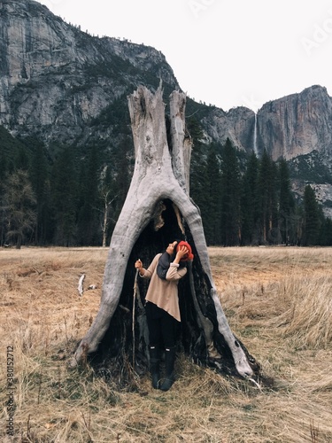 young woman in stump in yosemity photo