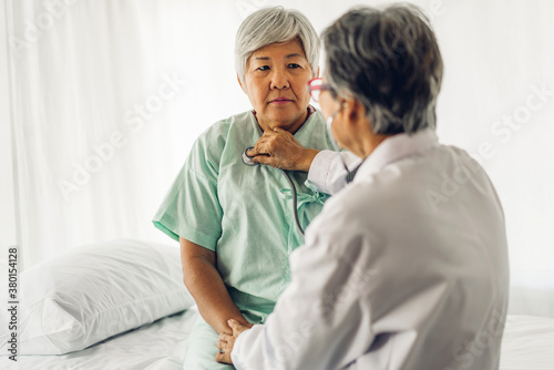 Female senior doctor consulting and examining senior woman patient with stethoscope in hospital.healthcare and medicine