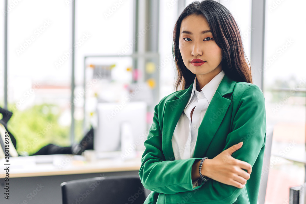 Beautiful smiling confident asian businesswoman in smart casual looking at camara.Young creative coworkers business people working and planning strategy analysis at office