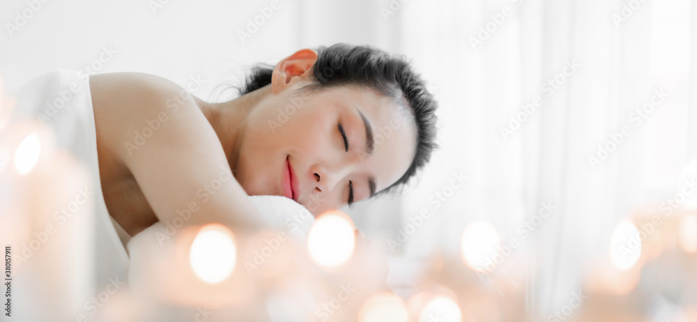 Smiling of young beautiful pretty asian woman clean fresh healthy white skin spa treatment relaxing lying on towel in massaging and spa salon Smiling of young beautiful pretty asian woman clean fresh healthy white skin spa treatment relaxing lying on towel in massaging and spa salon