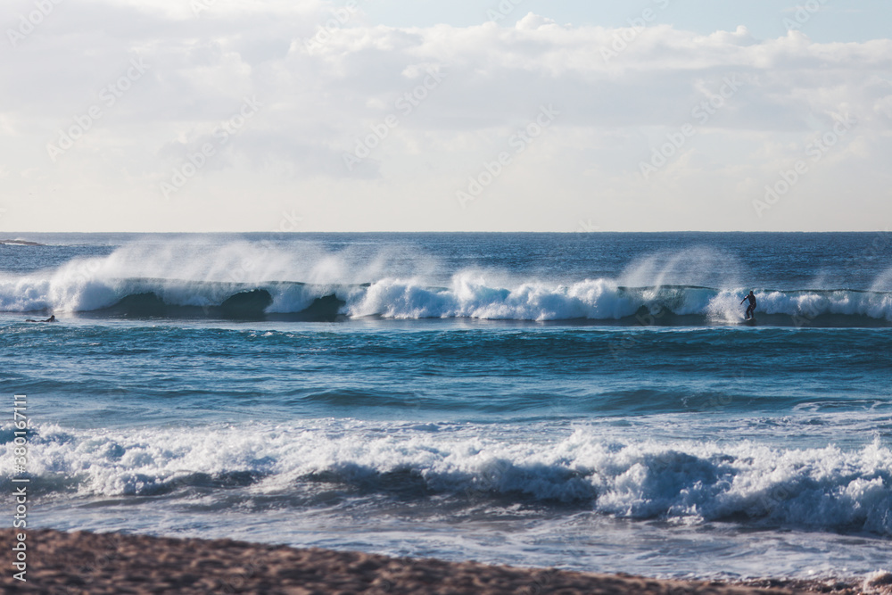 Surfer riding long wave on south east Australian beaches Surfer riding long wave on south east Australian beaches