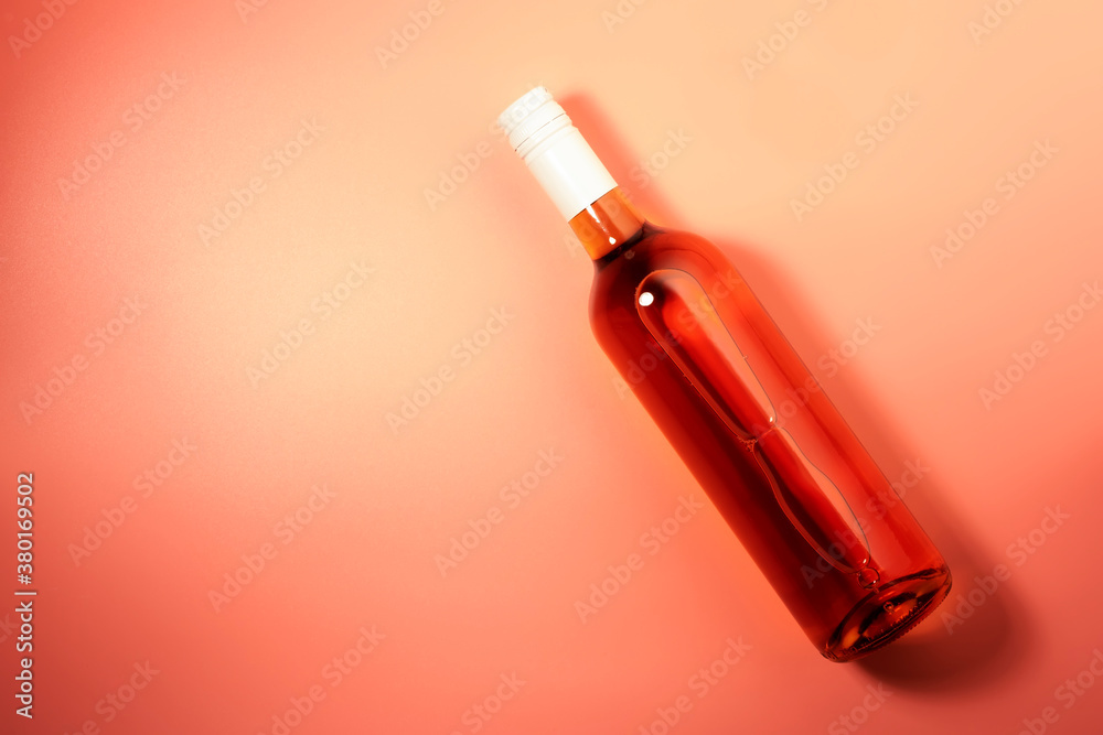 Rose wine bottle on pink background. Rosado, rosato or blush wine tasting in wineshop, bar concept. Copy Space, top view Rose wine bottle on pink background. Rosado, rosato or blush wine tasting in wineshop, bar concept. Copy Space, top view