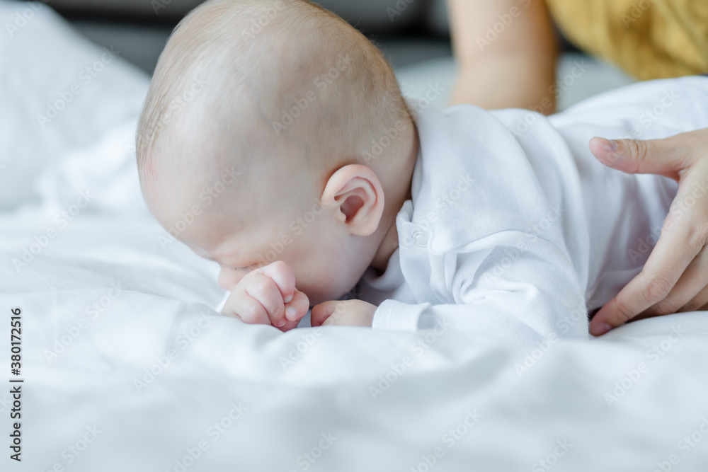 Happy mom and baby playing together on the bed at home . family love concept. Happy mom and baby playing together on the bed at home . family love concept.