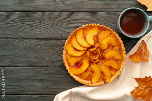 Homemade traditional sweet autumn tart pie on wooden table