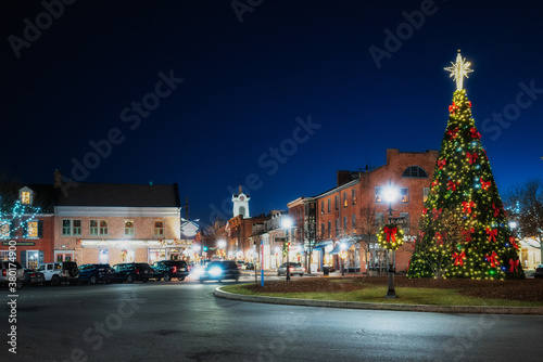 Decorated Christmas tree lit up at night with a star in the quaint village town square of historic Gettysburg, Pennsylvania. Winter holiday scenic. 