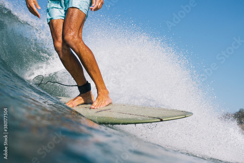 Surfer trims stylish down the line on his retro surfboard photo