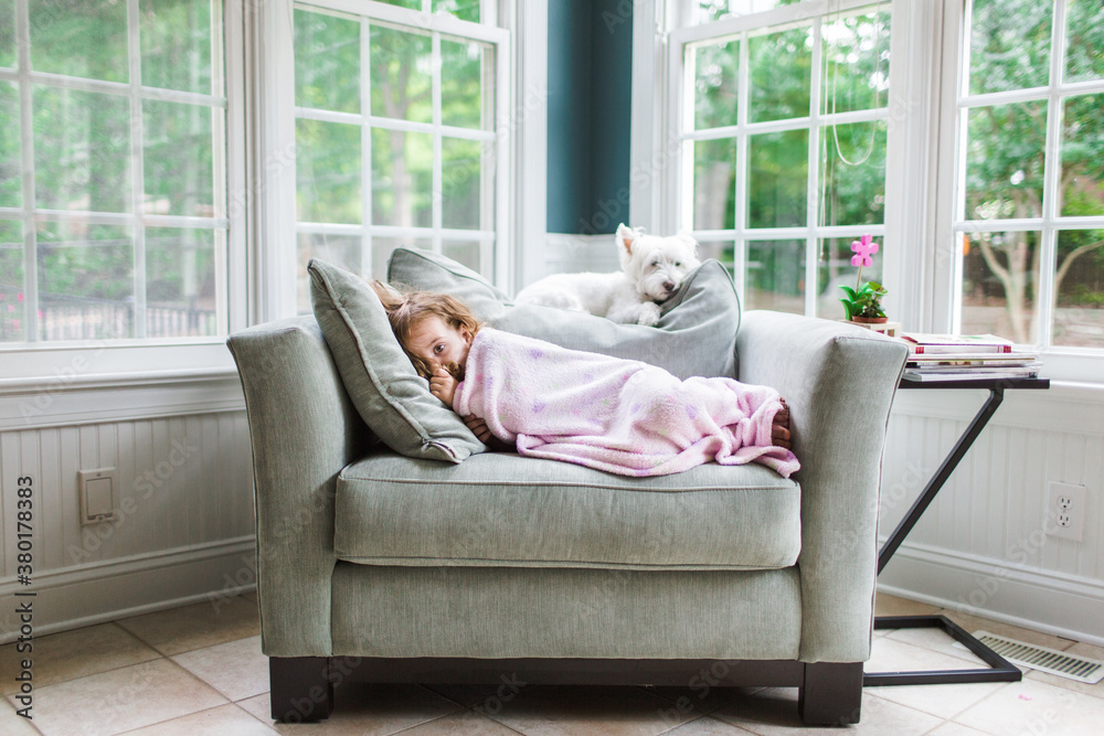 Dog and toddler relaxing on a big chair Dog and toddler relaxing on a big chair