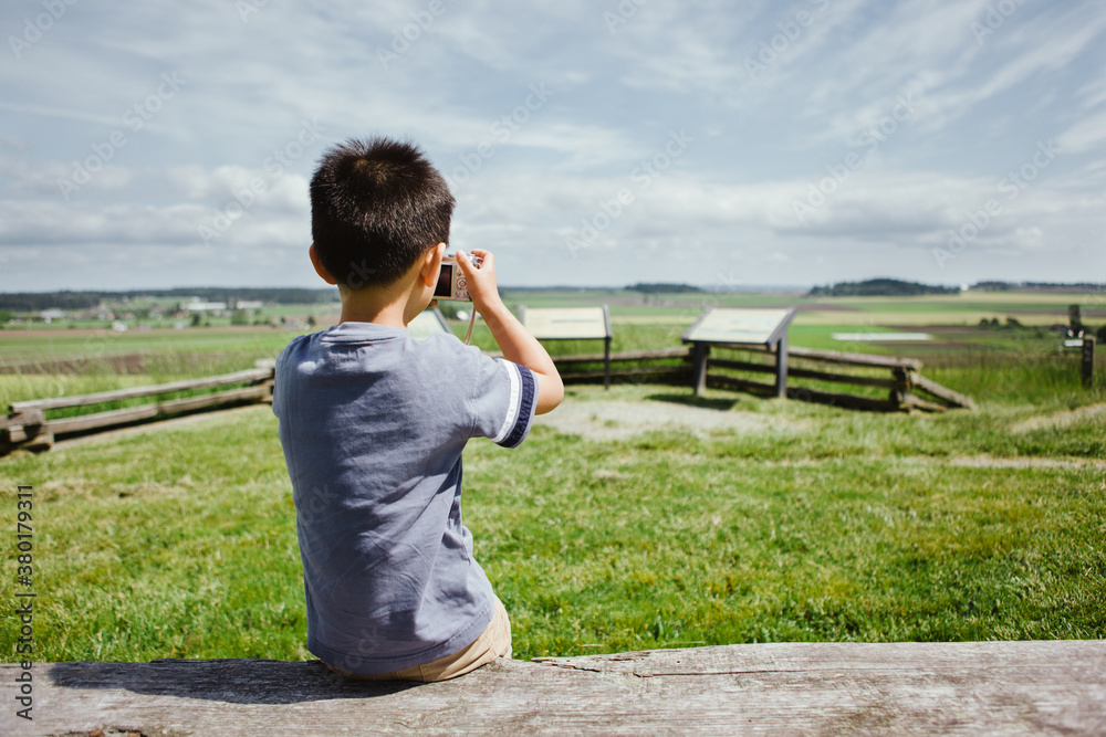Boy taking picture of a beautiful scenery Boy taking picture of a beautiful scenery
