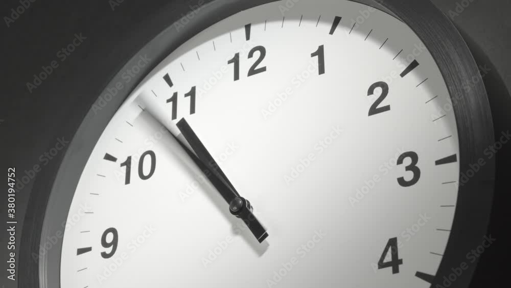 Clock Face in Time Lapse on Dark Grey Wall