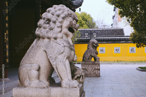 Stone lion in front of ancient temples in Suzhou,China photo