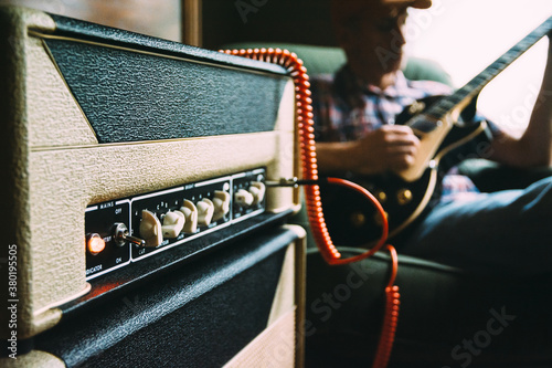 Guitar Player Practicing on an Electric Guitar And Vacuum Tube Amplifier