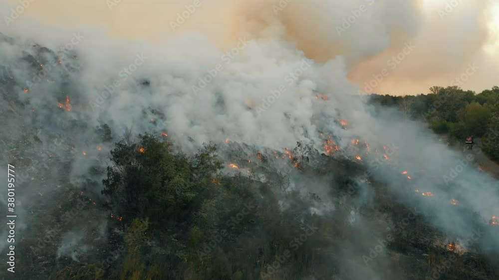 Aerial view at fire at garbage dump, burning pollutes the environment. Ecological catastrophe and destruction of nature, large fire area Aerial view at fire at garbage dump, burning pollutes the environment. Ecological catastrophe and destruction of nature, large fire area