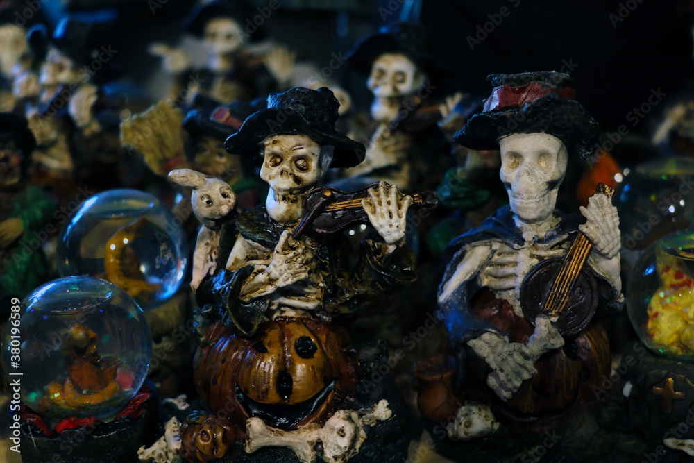 Halloween decoration. Scary figurines of the dead on the shelf.