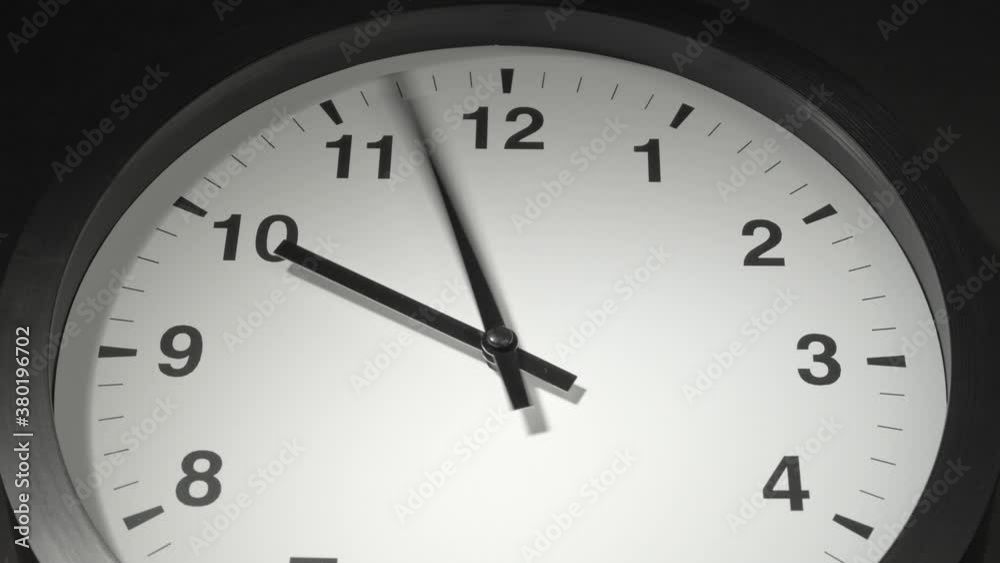 Clock Face in Time Lapse on Dark Grey Wall