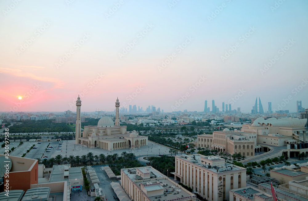 Panoramic Aerial View of Manama with the Al Fateh Grand Mosque and Group of Iconic Landmarks against Pastel Color Sunset Sky