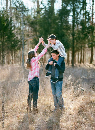 Three kids playing and hiking in a field and woods photo