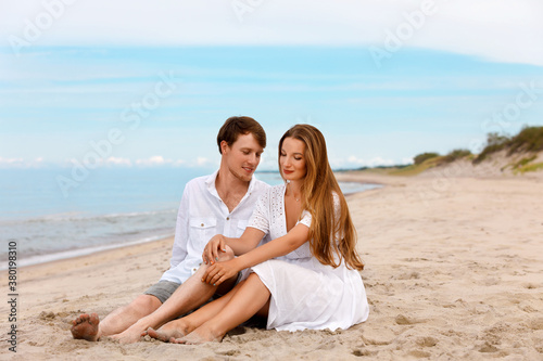 Young couple of sweethearts relax on the beach
