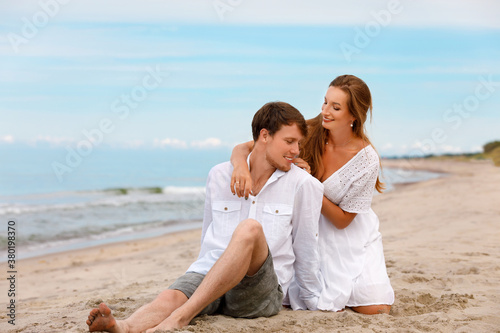 Pleasant couple of sweethearts resting on the beach