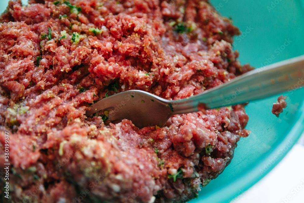 Spiced raw meat ready for making hamburgers for a bbq