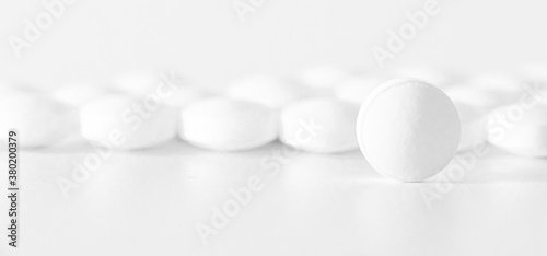 Image of white pills on white background. Medicine concept 