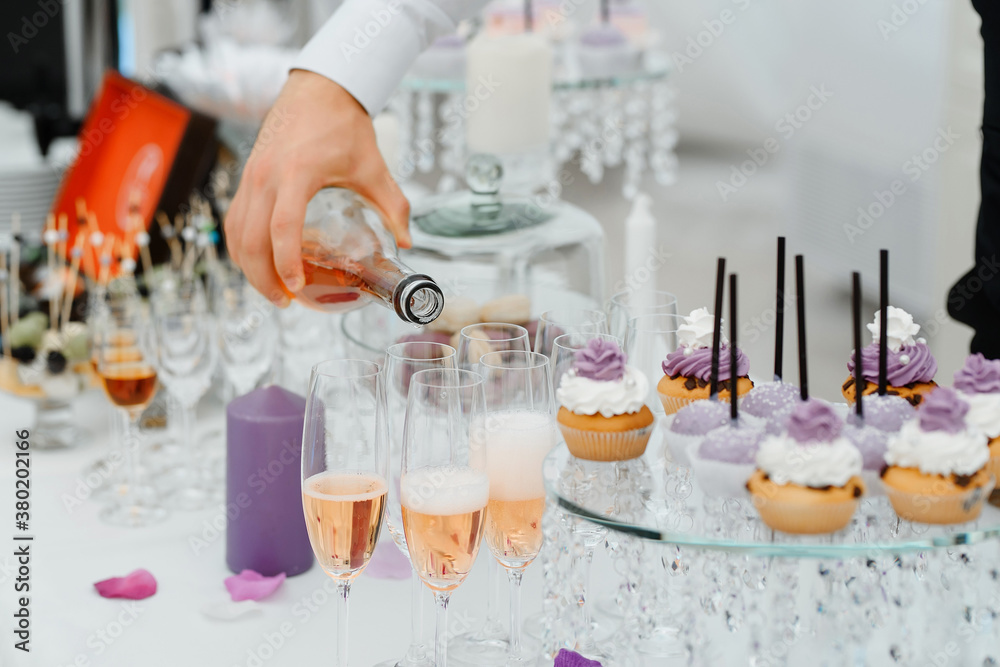 waiter hand pouring champagne in the glasses waiter hand pouring champagne in the glasses