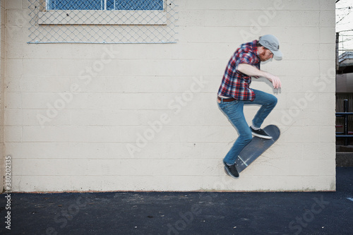 Skateboarder doing a wall ride photo