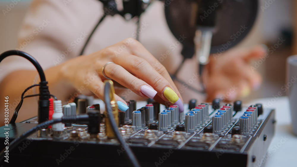 Content creator checking sound on dj mixer for better podcast. Creative online show presenter, On-air online production internet broadcast show host streaming live content, recording digital media Content creator checking sound on dj mixer for better podcast. Creative online show presenter, On-air online production internet broadcast show host streaming live content, recording digital media