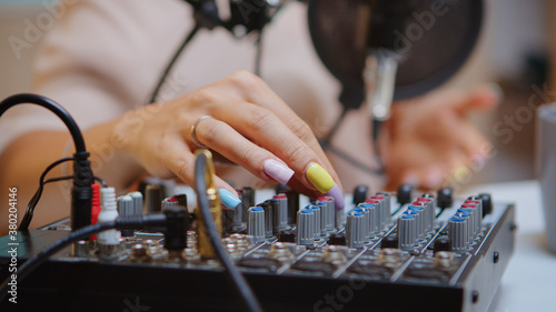 Content creator checking sound on dj mixer for better podcast. Creative online show presenter, On-air online production internet broadcast show host streaming live content, recording digital media