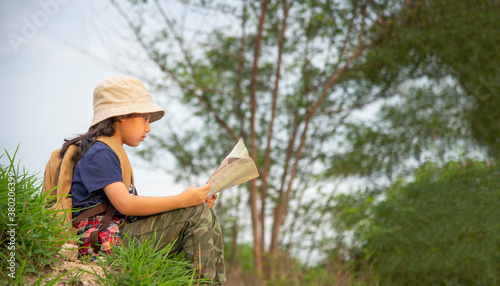 Kid girl Asian young woman holding camera and standing in the jungle adventure. Tourism for destination and leisure trips for education and relax in nature park. © tonjung