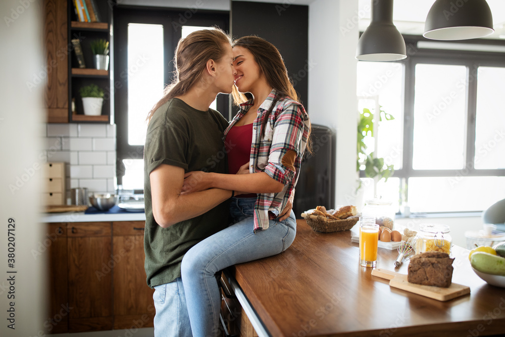 Romantic couple hugging and kissing, having a great time together.