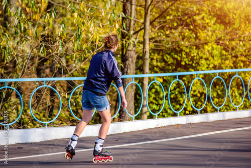 Girl roller skating in the autumn Park  © licvin