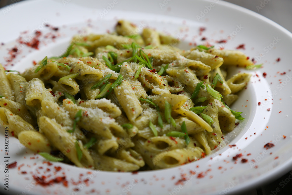 Penne pasta with pesto close up Penne pasta with pesto close up