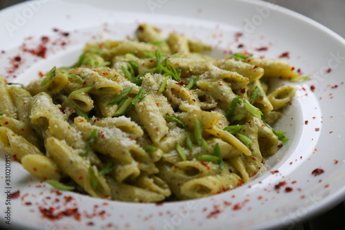 Penne pasta with pesto close up